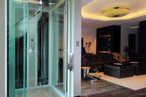 all glass paneled elevator in modern home