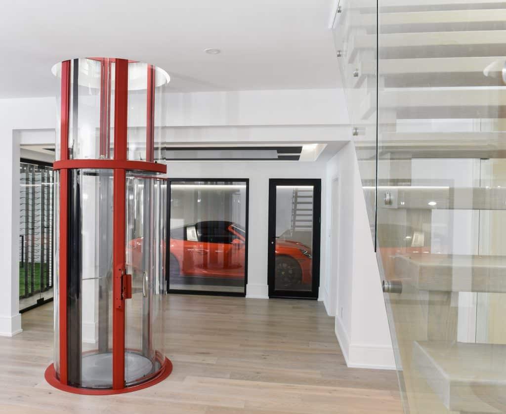 Round glass elevator with red trim