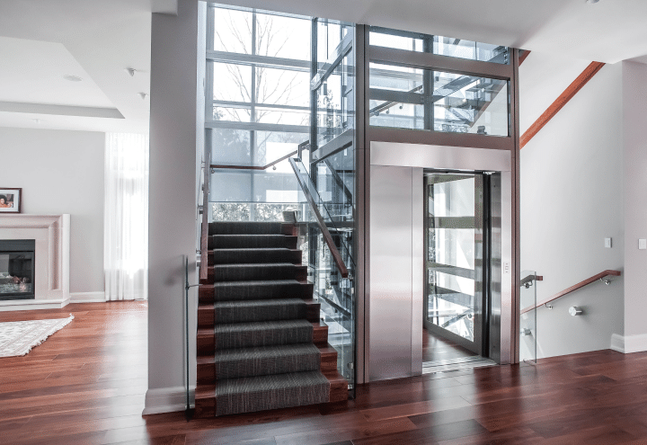 A glass elevator with metal trim